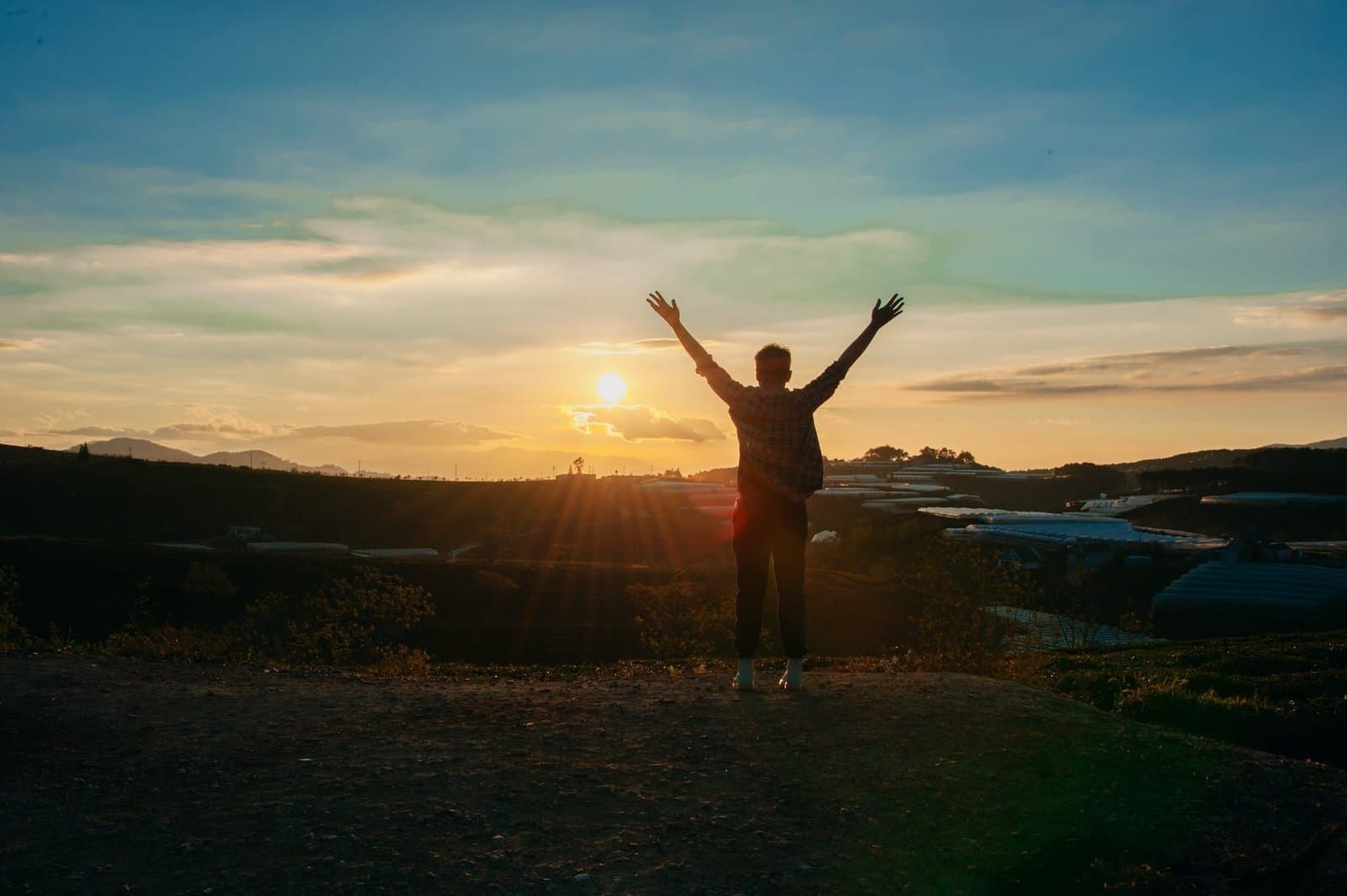 photography of man raising both hands for financial freedom as a landlord