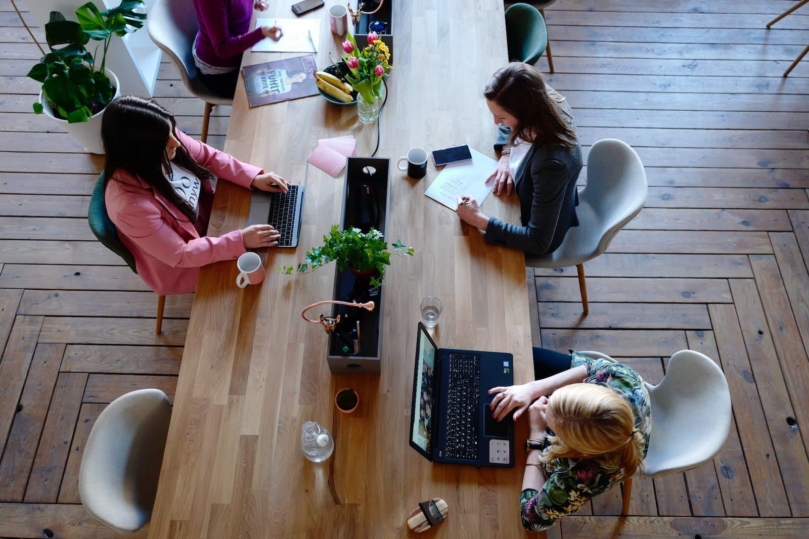 three woman sitting on white chair in front of table Commercial Real Estate Crash